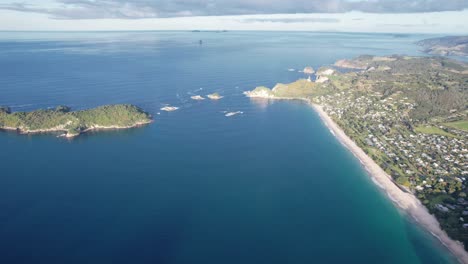 aerial view of a scenic coastal landscape with beach and town