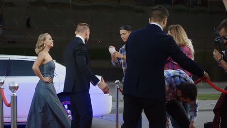 celebrity arrival at a red carpet event with paparazzi and security