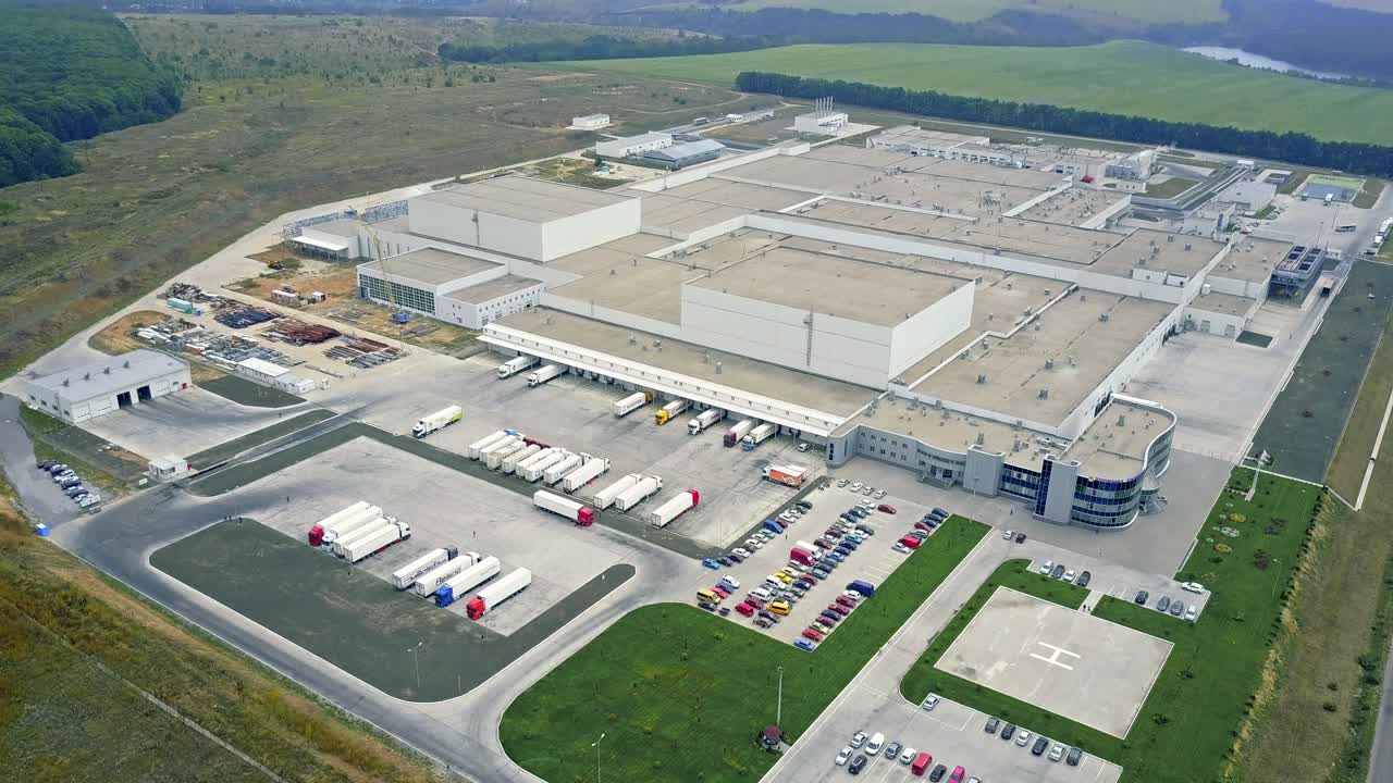 Gray facade made of aluminum panels with doors and windows on industrial building