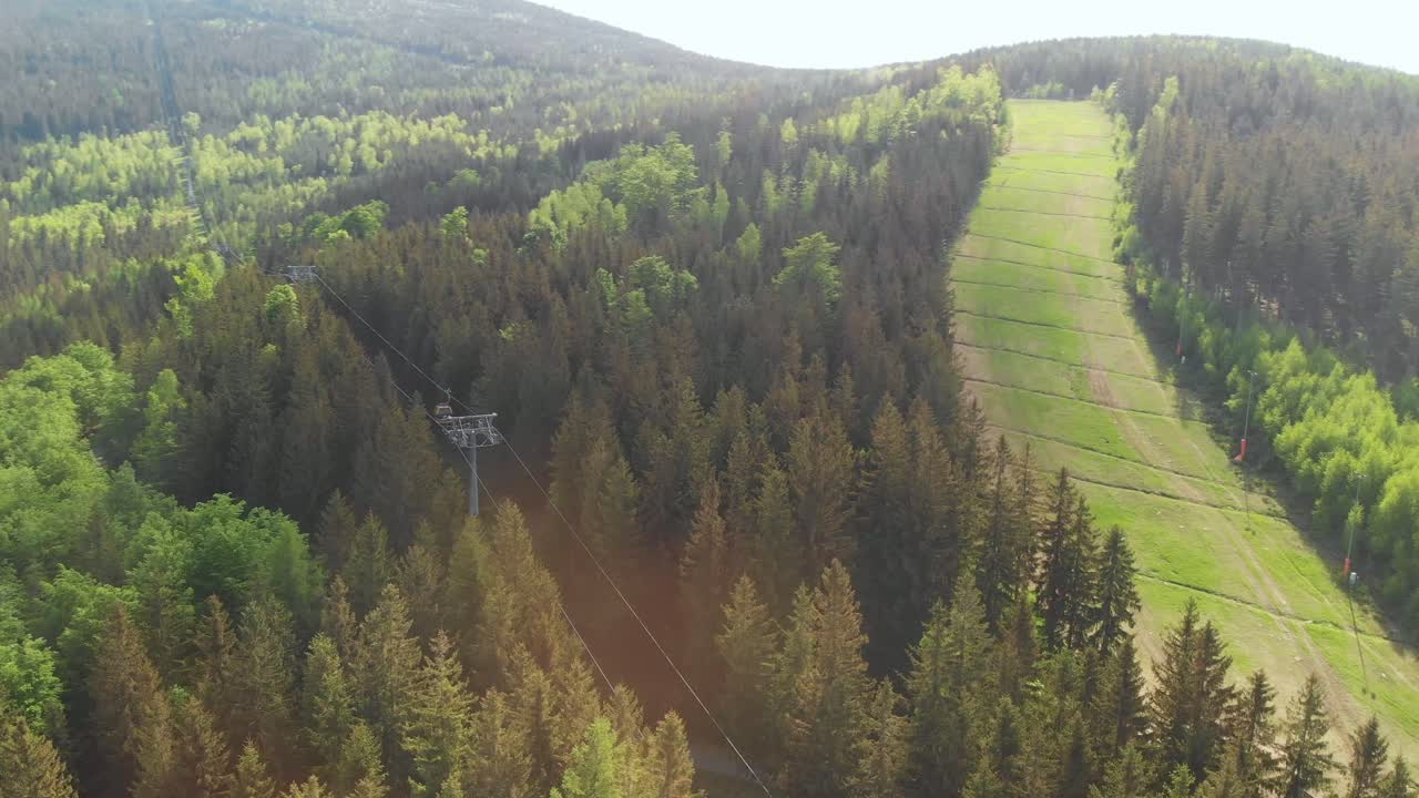 Aerial orbit over the slope converted to the mountain bike trail in the woods