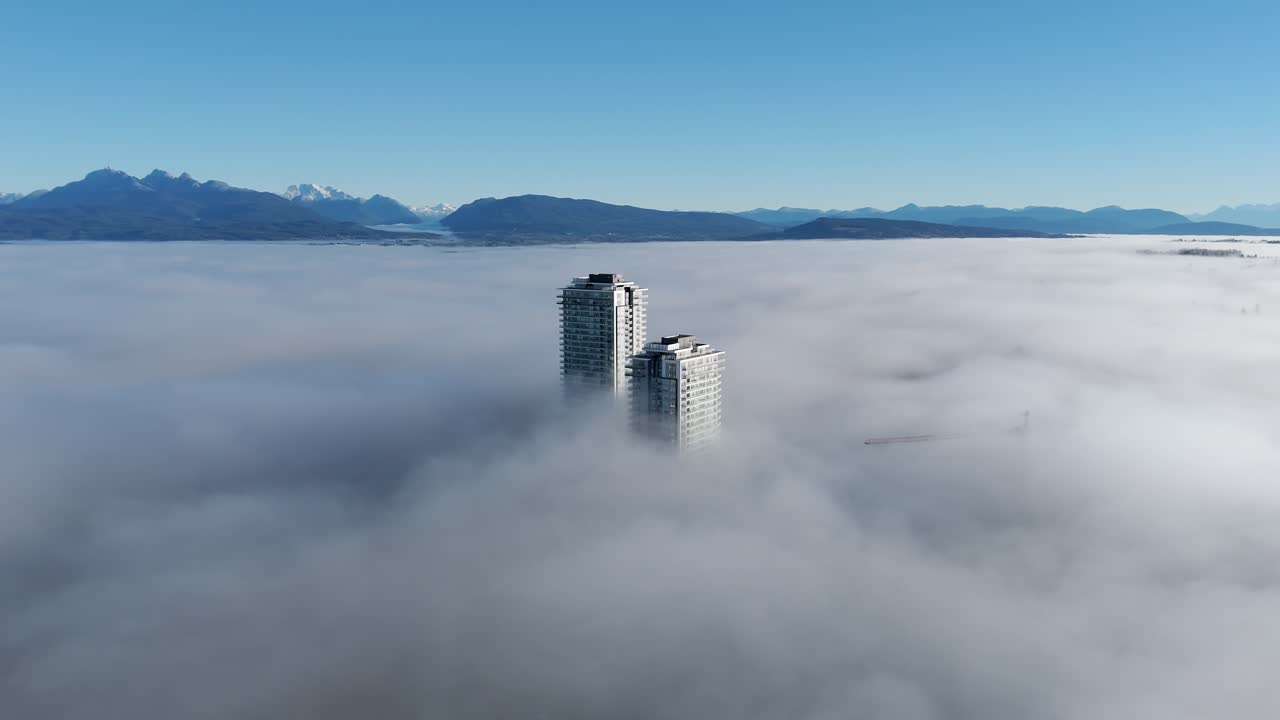 High Rise Buildings In Dense Fog During Sunrise In Langley, British Columbia, Canada. Aerial Shot