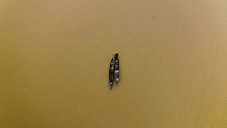 Fishermen-cruising-on-a-lake-in-their-canoes