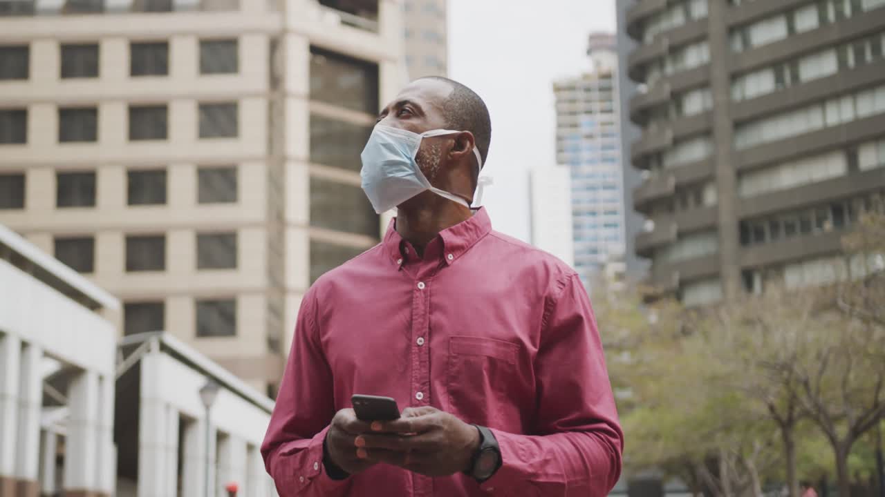 African american man on the go wearing coronavirus covid19 mask