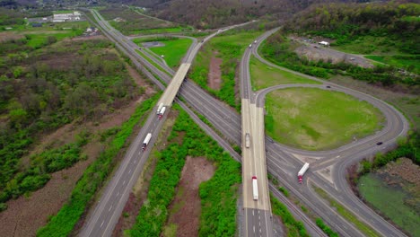 Aerial-of-Semi-Trucks-Navigating-Highway-Ramp-in-Pennsylvania,-United-States