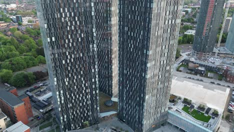 Aerial-drone-flight-at-Elizabeth-Square-in-Machester-City-Centre-with-a-slow-tilting-shot-from-the-base-to-the-rooftop-of-Deansgate-Towers