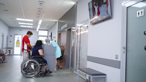 hospital waiting room with patients and staff