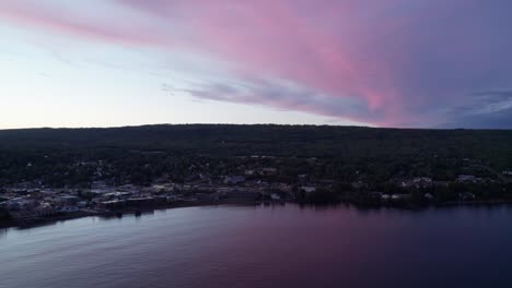 Drone-aerial-view-of-a-colorful-sunset-of-Grand-Marais,-MN-in-the-fall