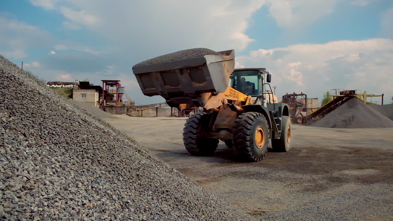 Mining truck driving along road. Industrial heavy machinery working at quarry