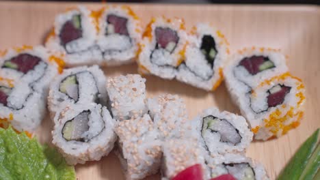 a drop-down shot showcases a decorative plate filled with a variety of sushi, highlighting the vibrant colors and intricate presentation. perfect for culinary, sushi, and food content.