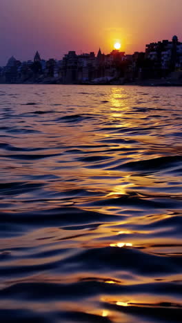 sunset over a tranquil river with a city skyline