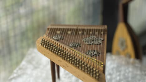 Close-up-shot-of-Miniature-musical-instrument-harp-rotating-in-place-as-decoration