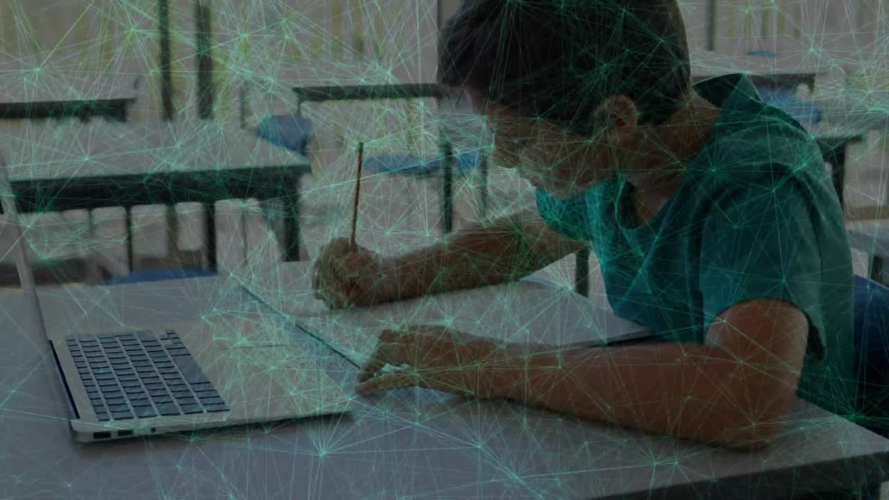 Animation of green dots connected with lines over caucasian boy writing in book and using laptop
