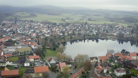 drone aerial view of the traditional german village herzberg am harz in the famous national park in central germany on a cloudy day in winter.