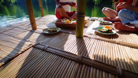 friends enjoying a picnic on a floating bamboo raft