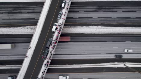 aerial fly-over of canadian freedom rally supporters waving canada flags demonstrating on highway 401