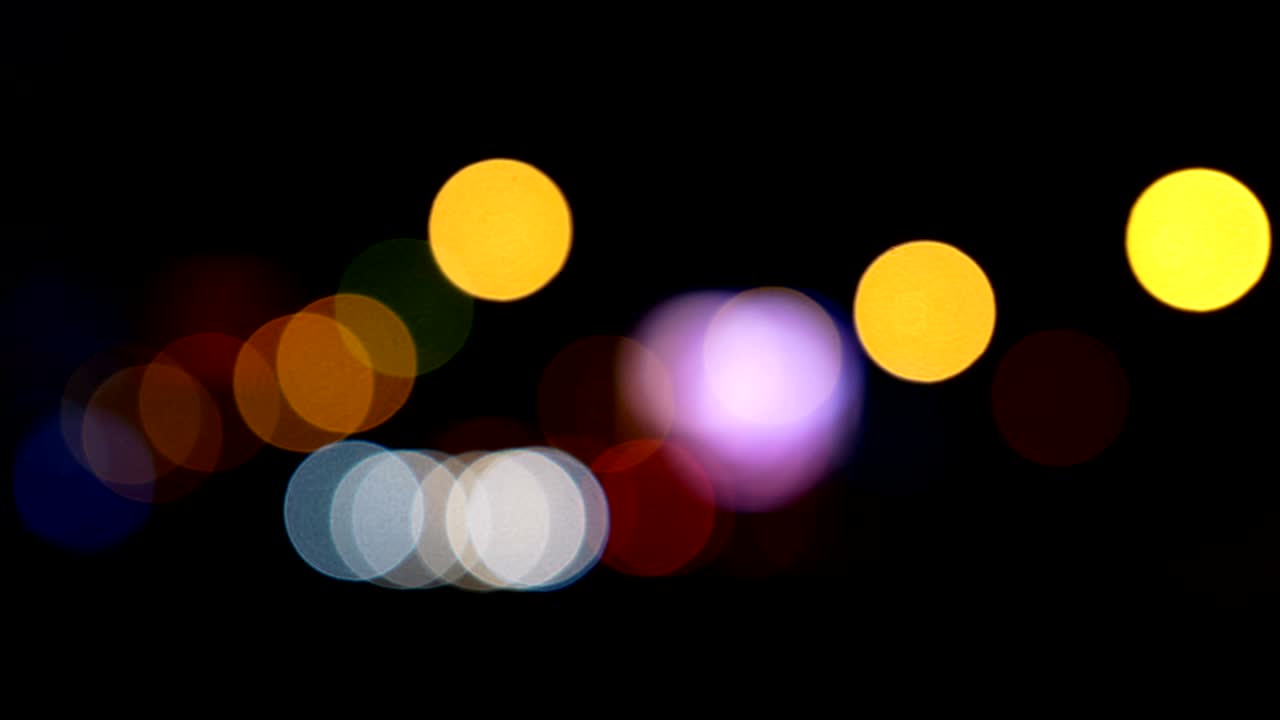 Defocused lights Los Angeles street abstract . City blur background. Moving bokeh circles of night traffic.