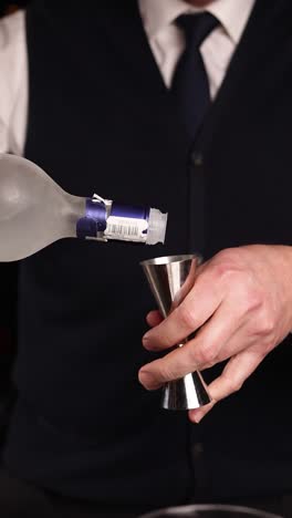vodka pouring into jigger
