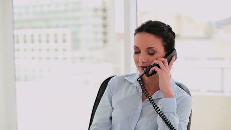 Happy-businesswoman-talking-on-the-phone