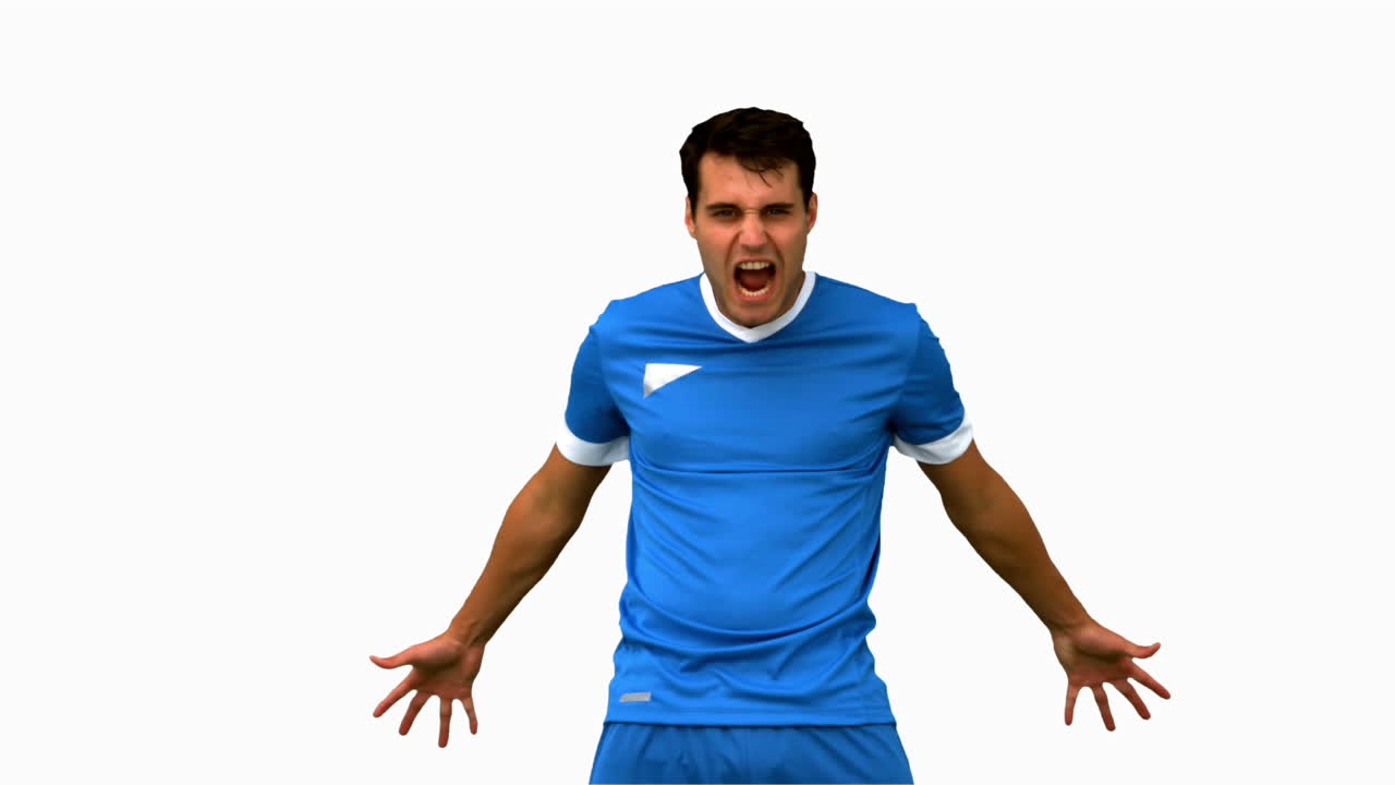 Angry football player holding his head on white screen in slow motion