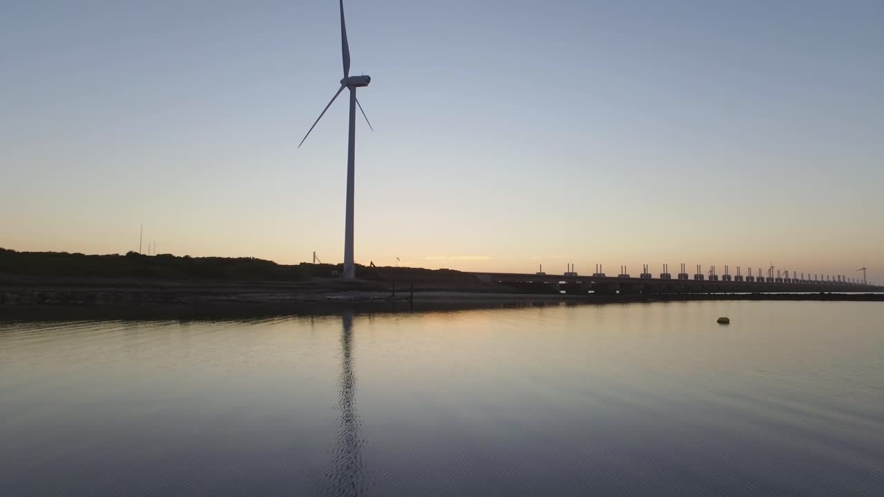 Wind Turbine at Sunset by the Water