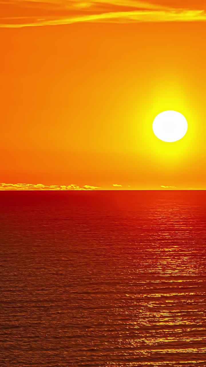 Vertical view of sunrise from sea horizon. Timelapse