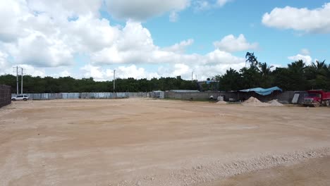 drone advancing to residential construction zone on flat terrain in preparation for excavation and construction, la romana, dominican republic