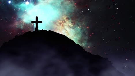 a cross silhouetted on a hill with a heavenly sky in the background