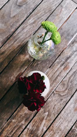 flowers in vases on wooden table