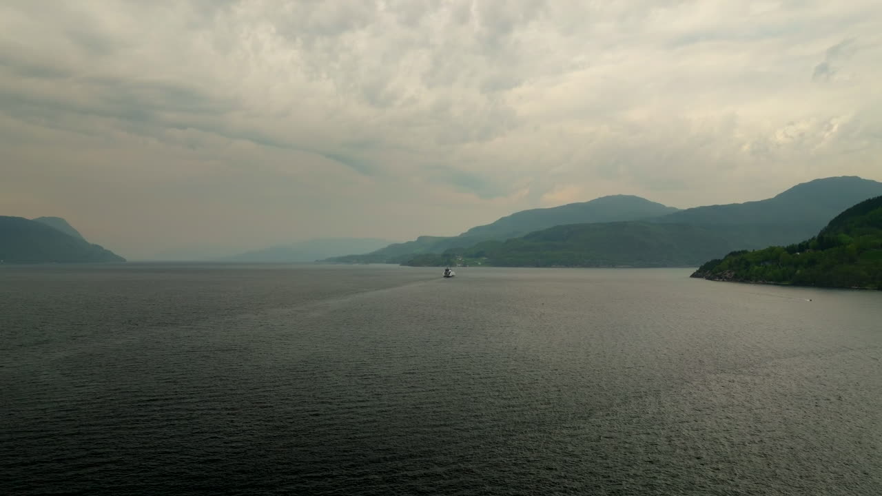 Long shot aerial view of MF Hydra liquid-hydrogen ferry cruising in Norway fjord