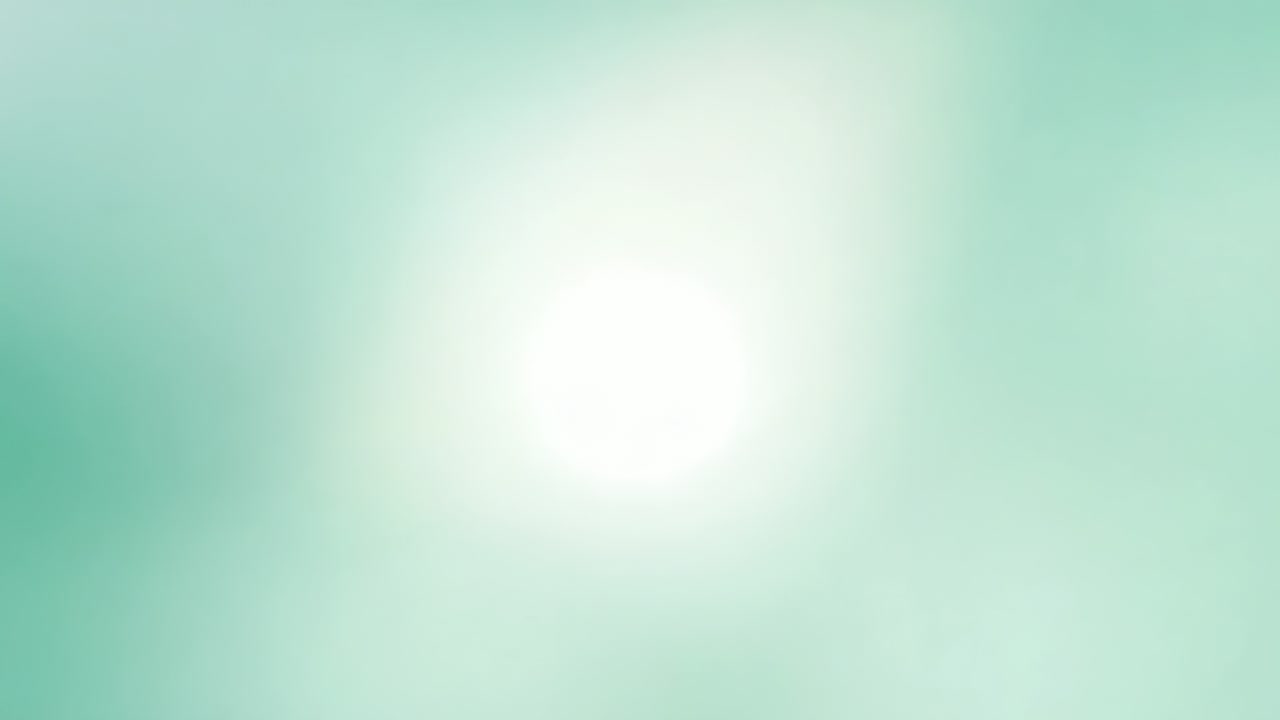 En framträdande ljus vit cirkulär flare som ljusnar och expanderar i ett turkosfärgat fält, bildar små klot