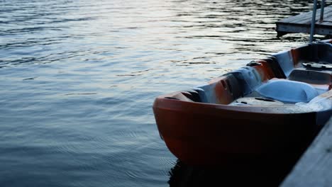 orange boat gently rocking on serene water