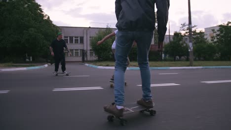 group of young people skateboarding on the road in the early morning, cinematic shot, slow motion