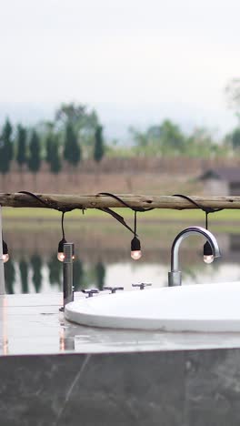 outdoor bathtub filling with steamy water
