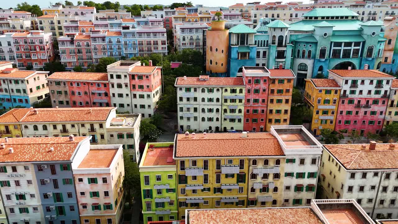 Aerial: Sunset Town buildings and architecture during the day, a fake Italian city in Phu Quoc Island, Vietnam, pan drone shot