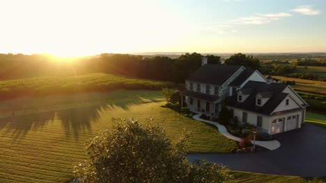 gorgeous aerial establishing shot of large home during summer sunrise