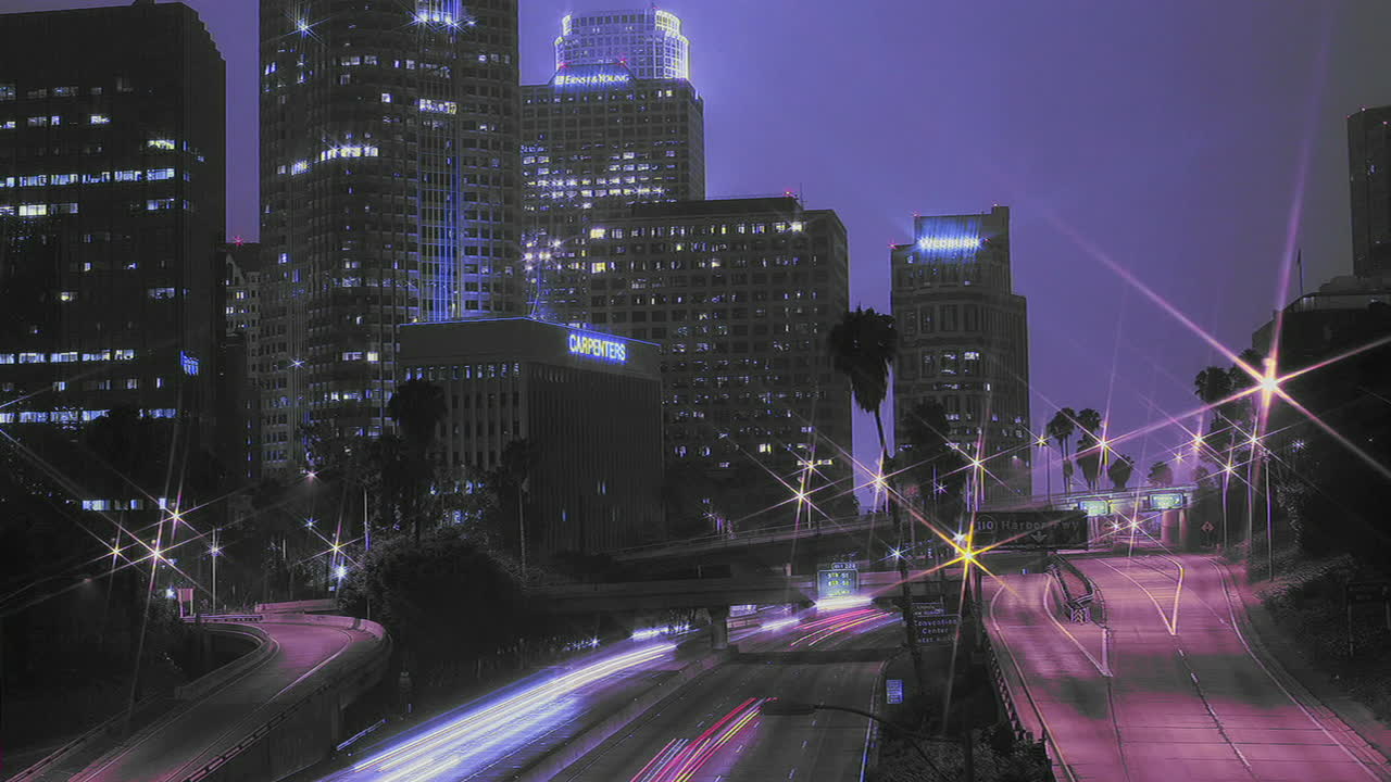 Excellent shot of heavy traffic driving on a busy freeway in downtown Los Angeles at night 1