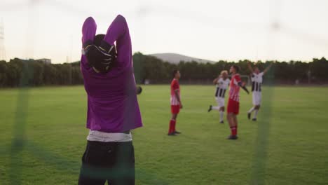 video of diverse gorup of male football players on field,playing football