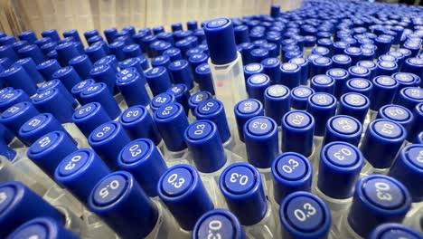 single blue pen popping up above hundreds of others - stationery store. tops visible grouped vertically in array
