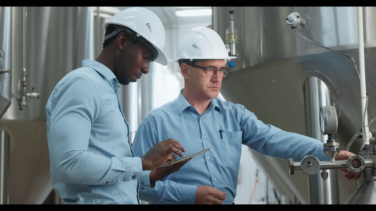 Engineers Inspecting Brewery Equipment