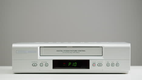 hand inserting cassette into vintage vcr