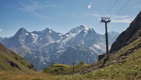 a captivating scene: majestic mountains soar, clad in sparkling white snow, the stunning view reveals chairlift poles boldly standing in the grandeur of this majestic atmosphere