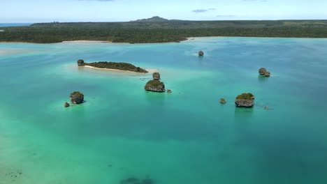 the rock islets in upi bay on the isle of pines in new caledonia - aerial parallax panorama