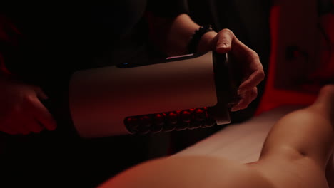 a woman receiving a massage with a massage gun