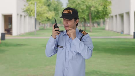 Angry-Indian-security-guard-giving-instructions-on-walkie-talkie