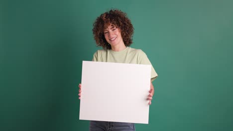 happy woman holding blank paper in green background
