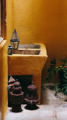 moroccan-inspired courtyard with antique lanterns and decorative basin