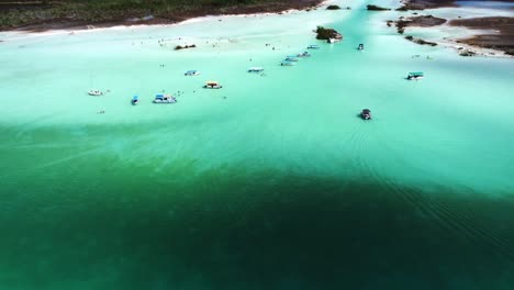 Bacalar-stunning-blue-water-lake-lagoon-with-tropical-sandy-beaches-boat-moored-at-bay-waiting-for-tourist-for-local-tour