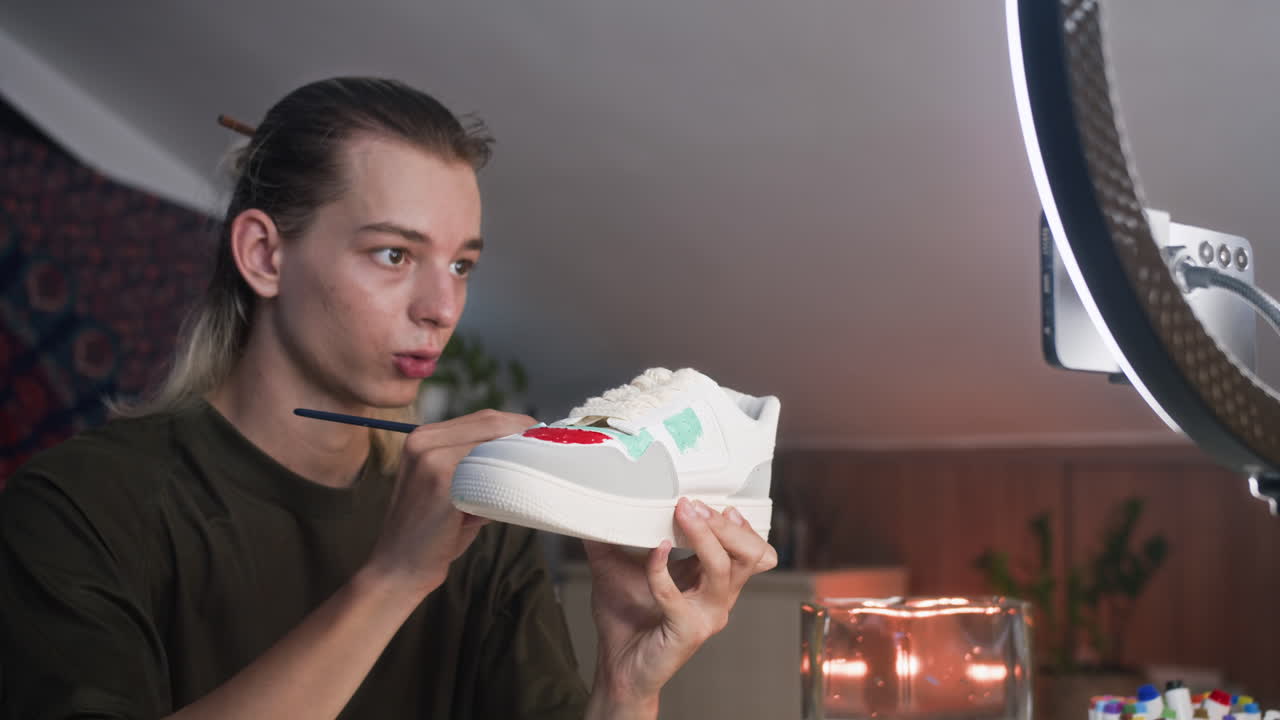 Fashion Blogger Painting Sneakers on Smartphone Camera