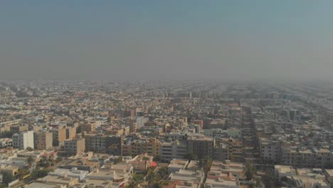 aerial over neighbourhood skyline of clifton cantonment in karachi, pakistan. follow shot
