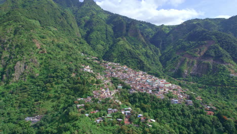 drone footage of volcanic mountainside indigenous town santa cruz la laguna, guatemala in lake atitlan in central america highlands surrounded by lush rainforest hill